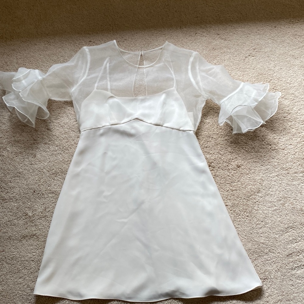 Amanda Uprichard white mini dress with flutter crinoline sleeves.